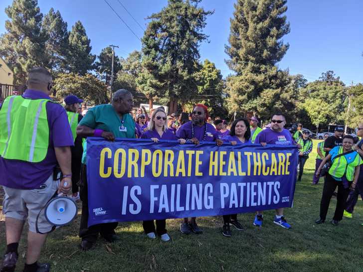 CKPU healthcare workers holding banner reading 
